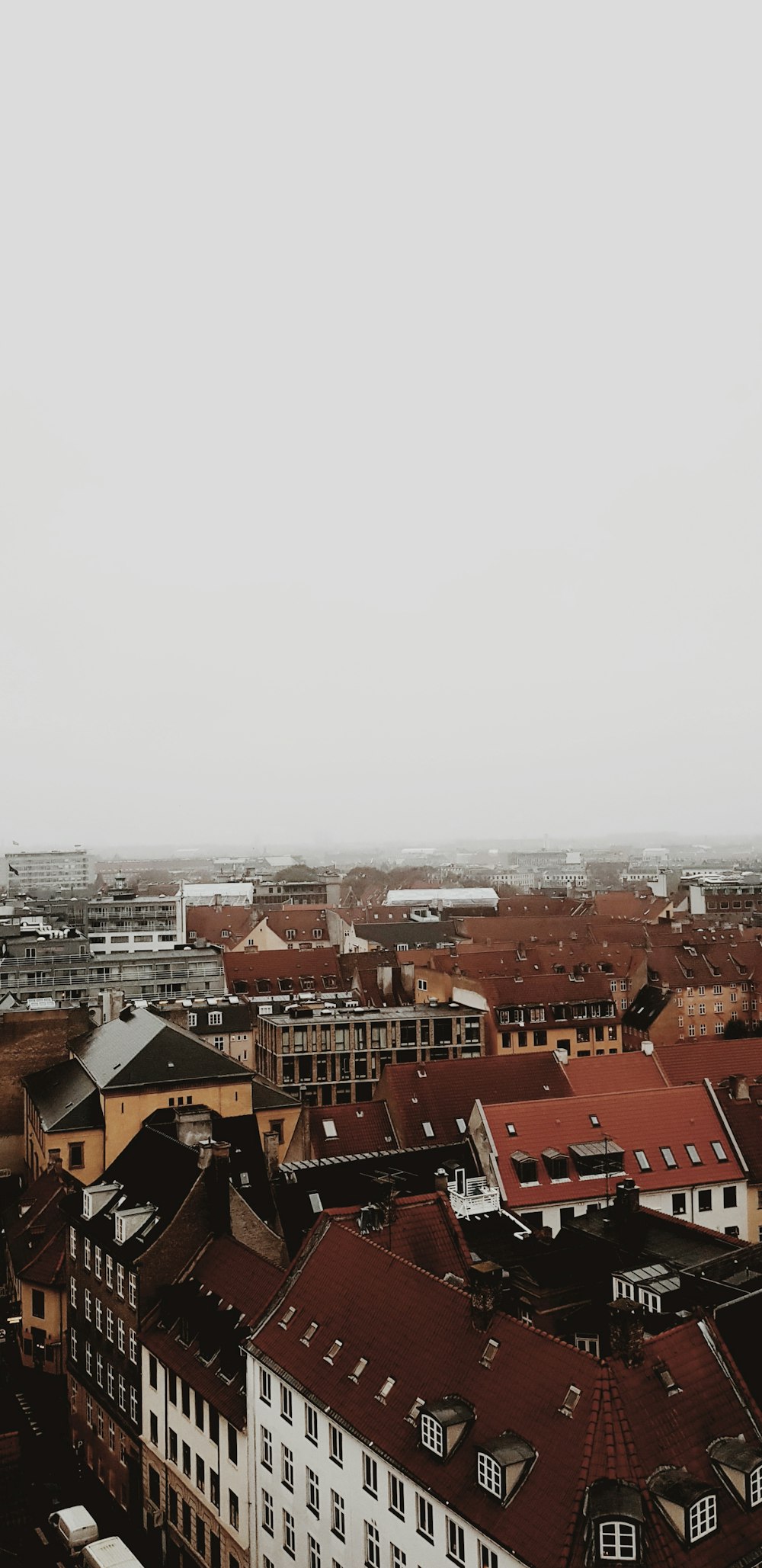 brown and white concrete houses under white sky during daytime