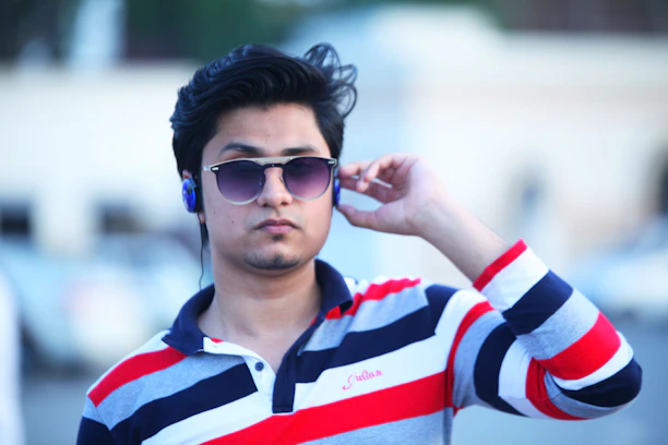 A lifestyle photo showing someone using Ray-Ban Meta glasses while jogging in a park, with earbuds visible.