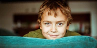 boy in green shirt smiling