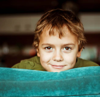 boy in green shirt smiling