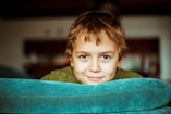 boy in green shirt smiling