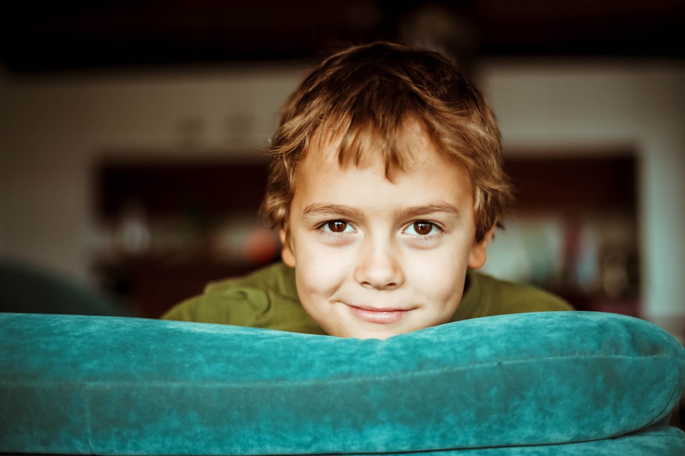 boy in green shirt smiling