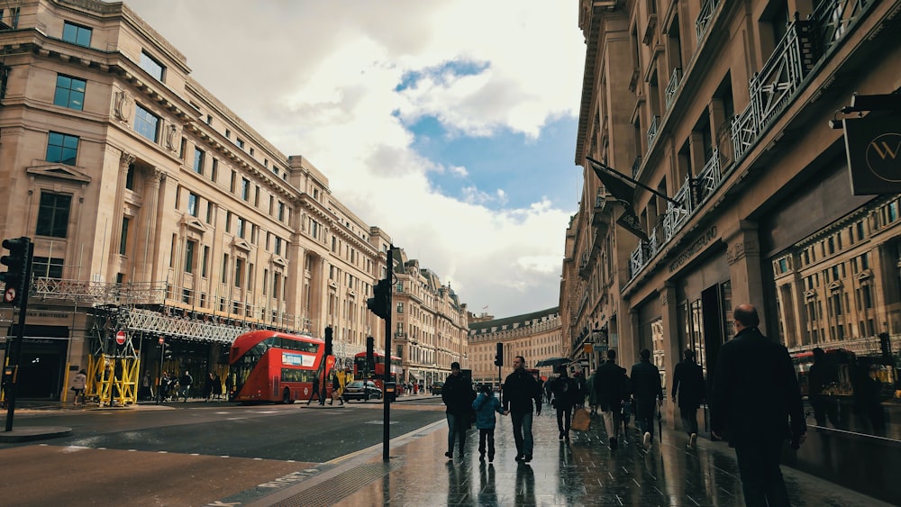 people walking on street between buildings during daytime