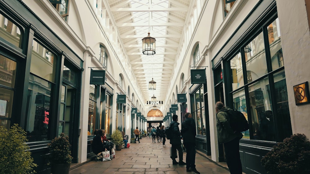 people walking on white and gray tiled floor