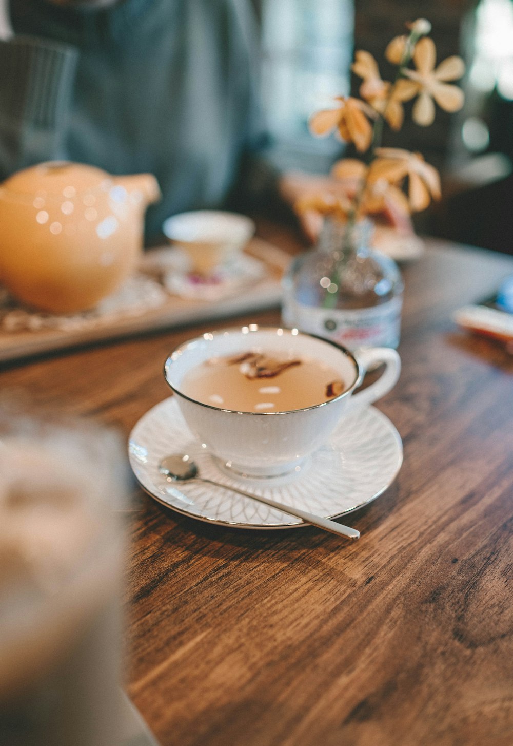 white ceramic teacup on saucer