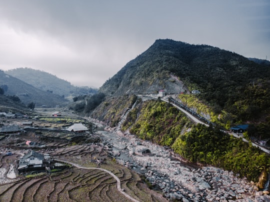 green mountain under white sky during daytime in Sapa Vietnam