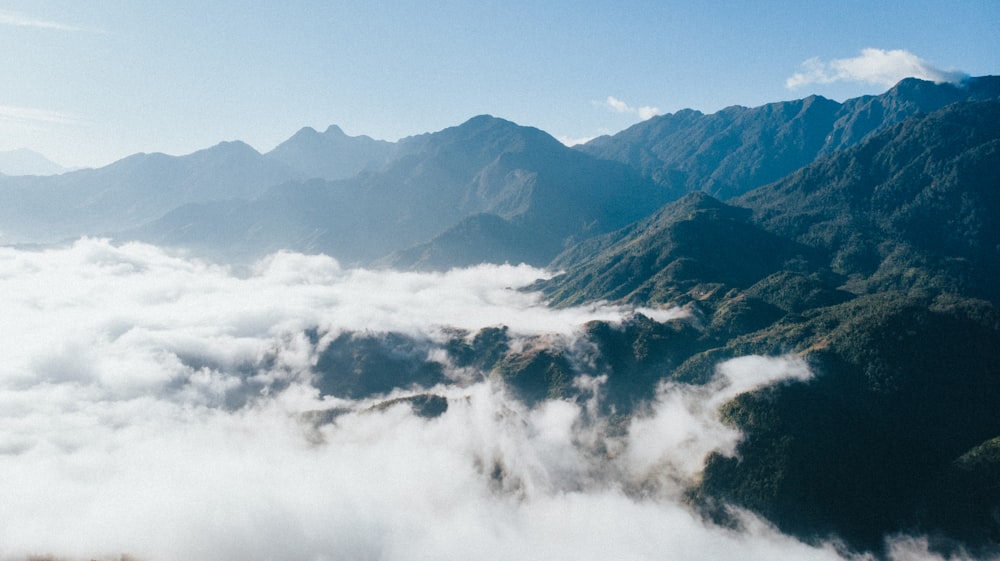 white clouds over mountains during daytime