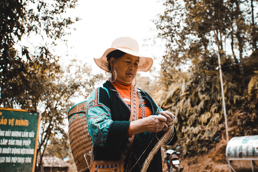 woman in brown hat and blue and brown scarf