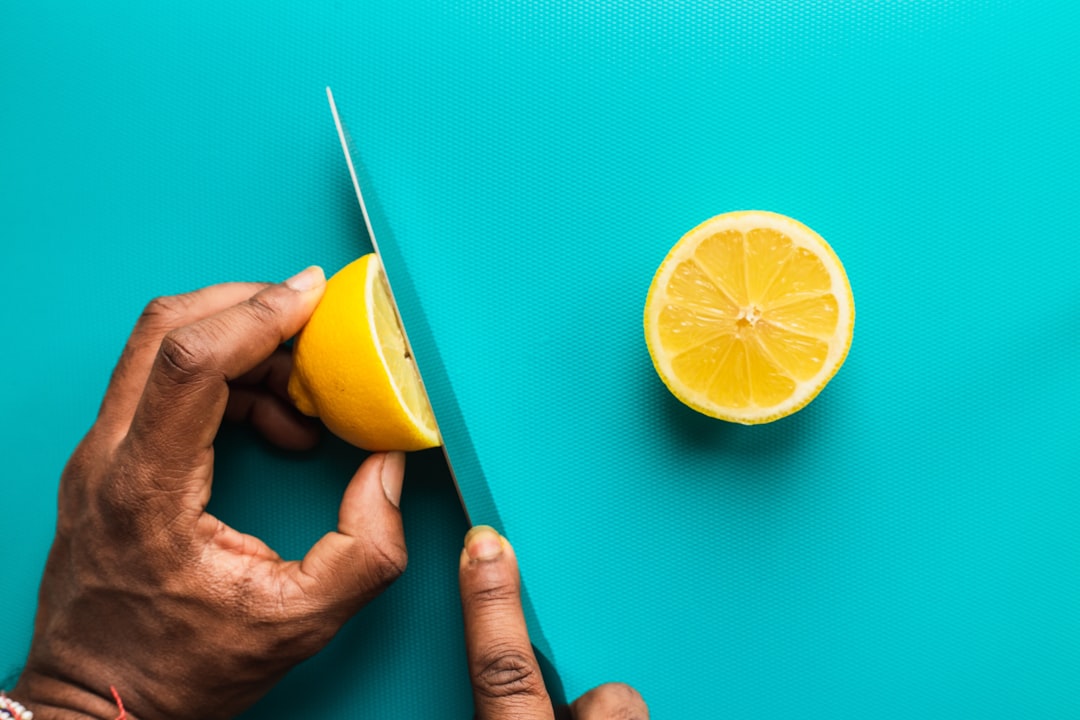 person holding sliced lemon fruit