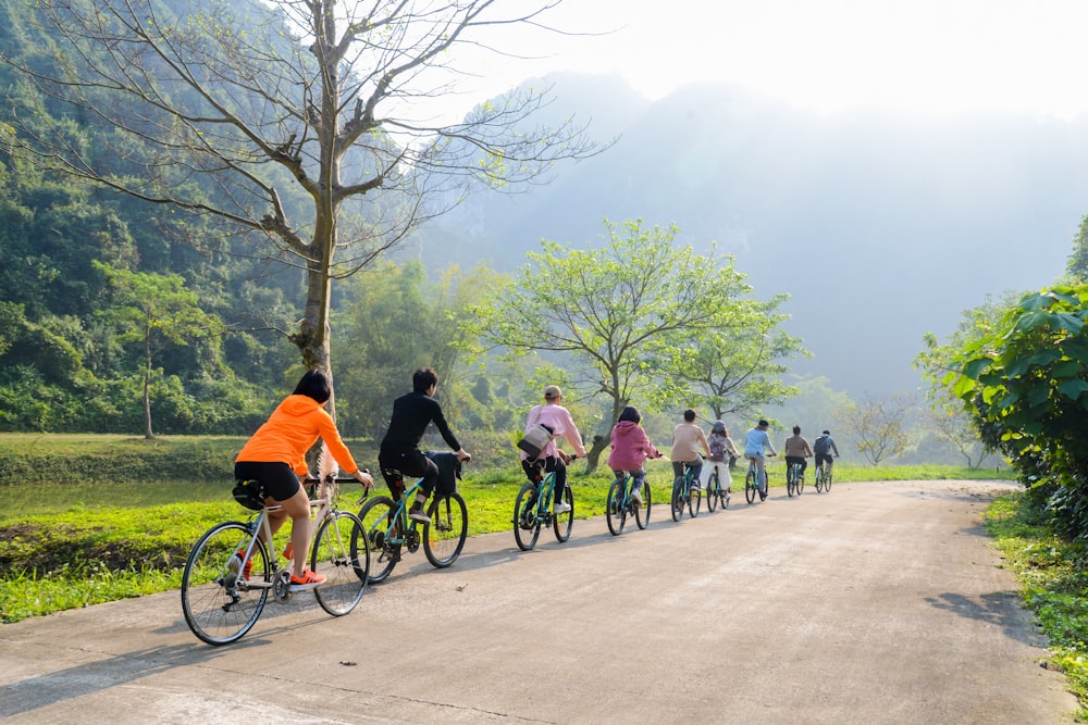 people riding bicycle on road during daytime