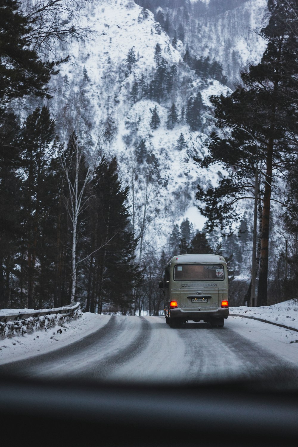 a van driving down a snow covered road