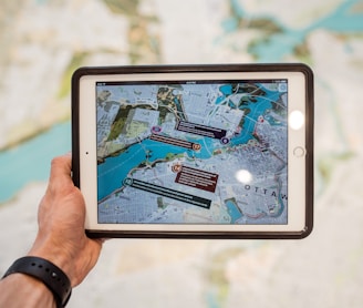 person holding white ipad with black case