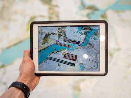 person holding white ipad with black case