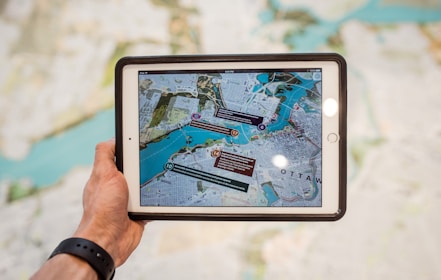 person holding white ipad with black case