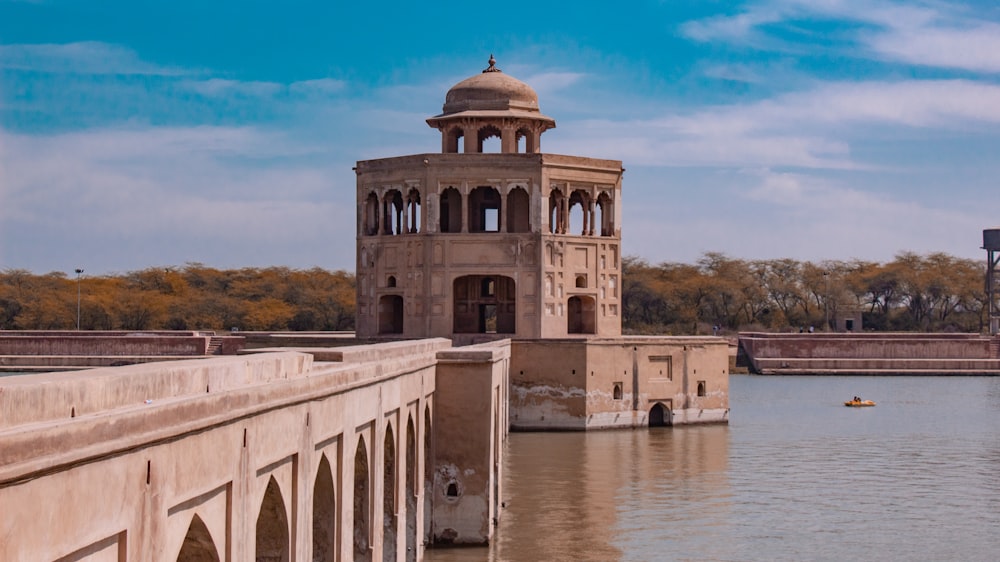 brown concrete building near body of water during daytime