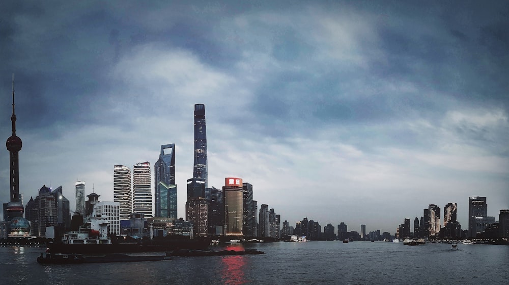 city skyline across body of water during daytime