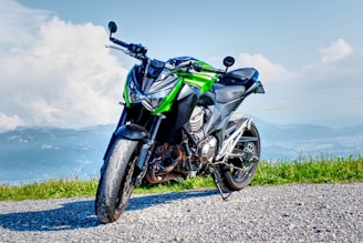 black and green sports bike on gray dirt road during daytime