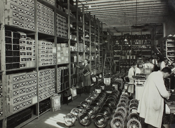 Photo of workers carefully assembling small technical components in a clean, organized industrial setting.