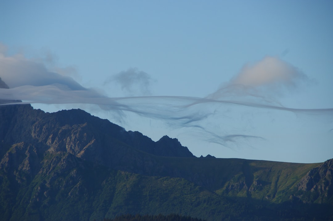 brown and green mountains under white clouds during daytime