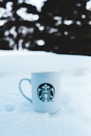 White ceramic mug featuring a detailed sublimation print with a business logo.