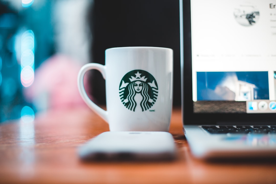 white starbucks ceramic mug on brown wooden table