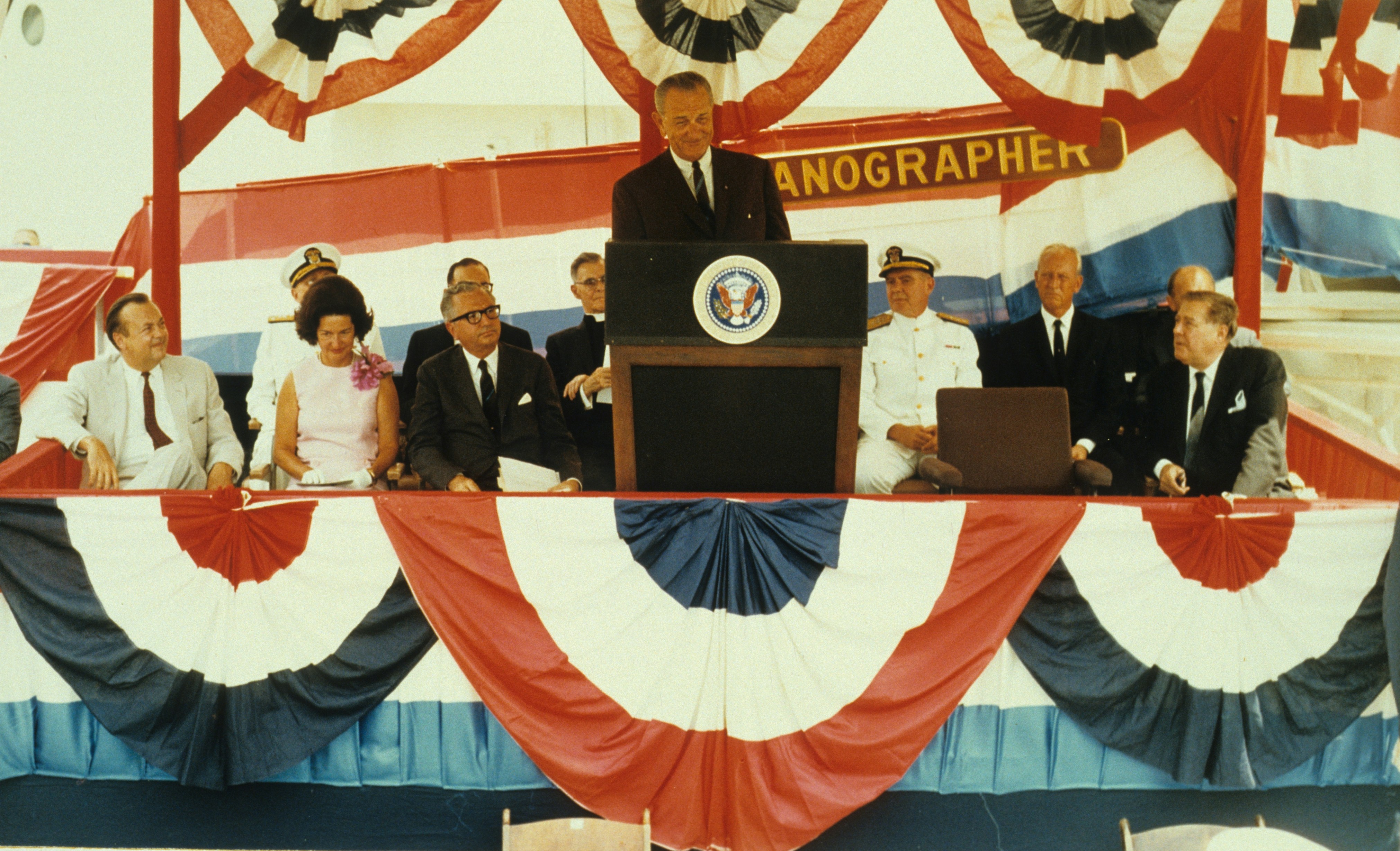 President Lyndon Baines Johnson speaking at the commissioning ceremony of theCoast and Geodetic Survey Ship OCEANOGRAPHER. Lady Bird Johnson issecond from left in the front row.