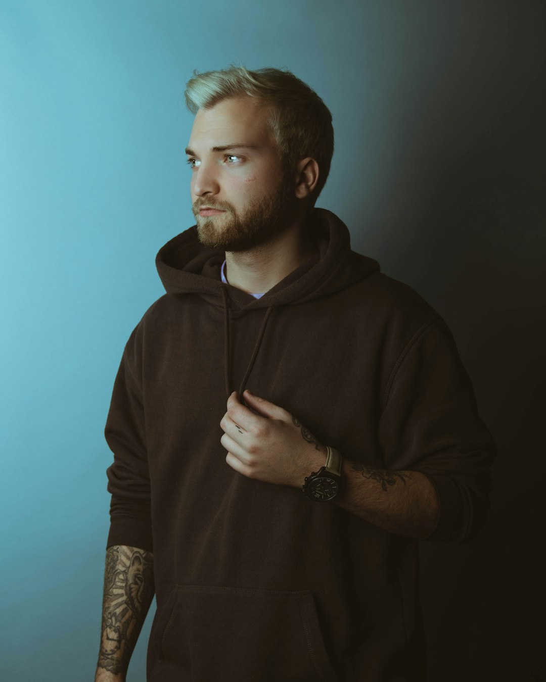 man in brown hoodie standing