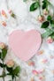 pink heart shaped paper on white and pink floral textile