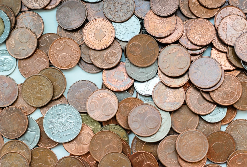 silver and gold coins on white surface