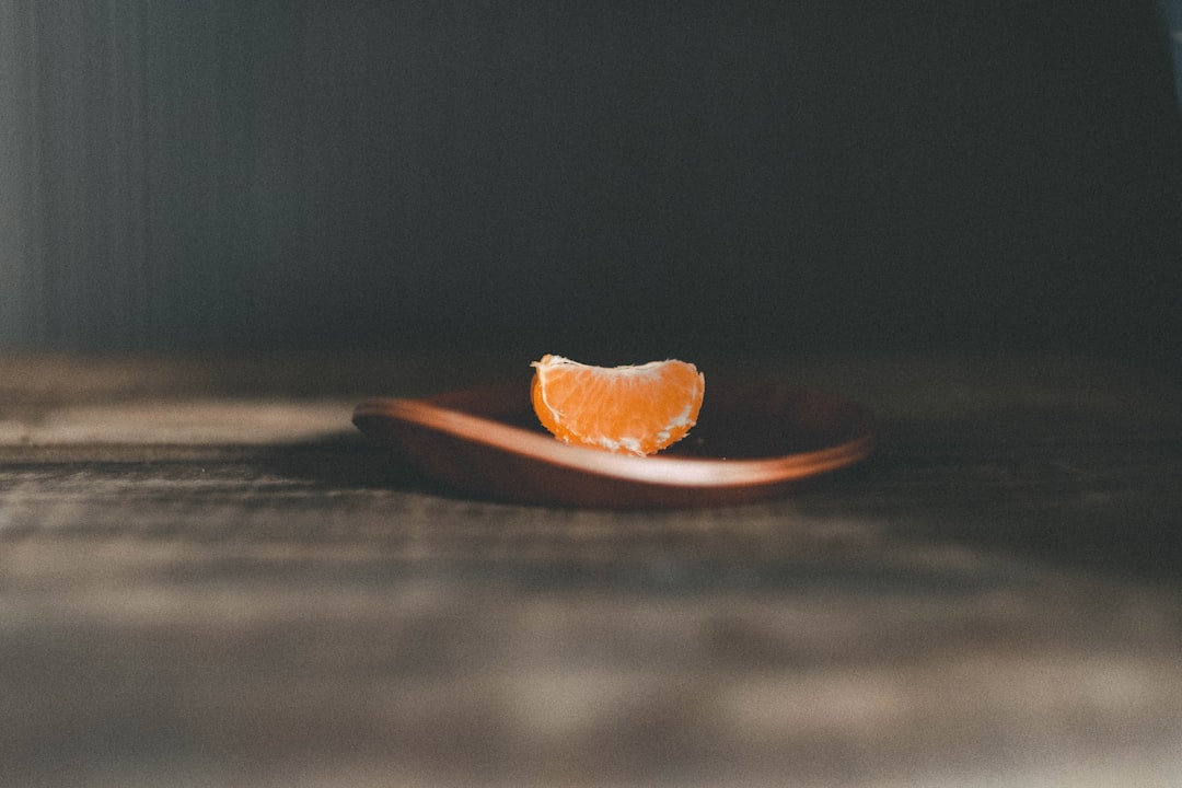 orange fruit on brown wooden round plate