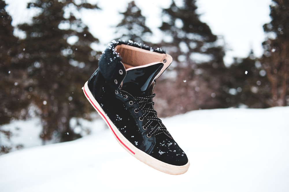 black and white nike basketball shoes on snow covered ground