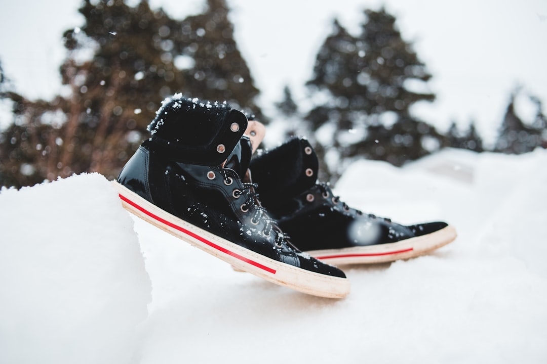 black red and white air jordan 1s on snow covered ground