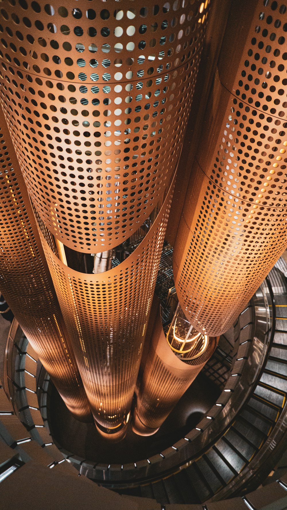 brown metal spiral stairs with stainless steel railings