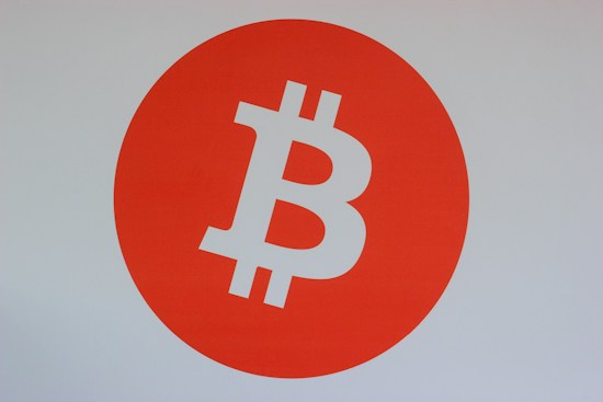 A bold orange circle dominates the center, featuring a prominent white Bitcoin logo, symbolizing cryptocurrency.