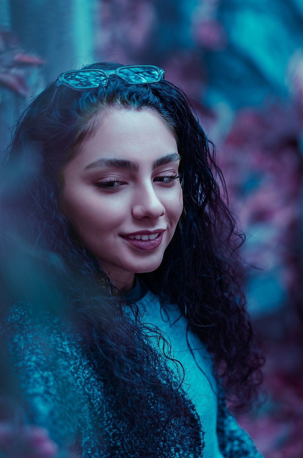 woman in teal shirt smiling