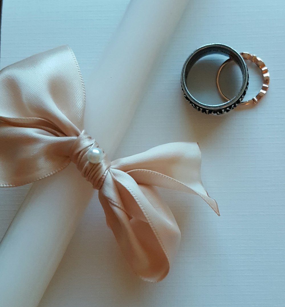 white and black round magnifying glass with white ribbon