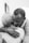 A heartfelt embrace between two people, one with short gray hair and the other with close-cropped hair. The setting appears intimate, suggesting comfort and warmth.