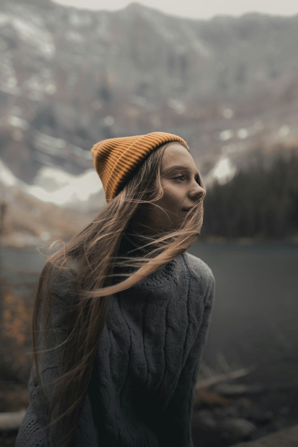 woman in gray coat and brown knit cap