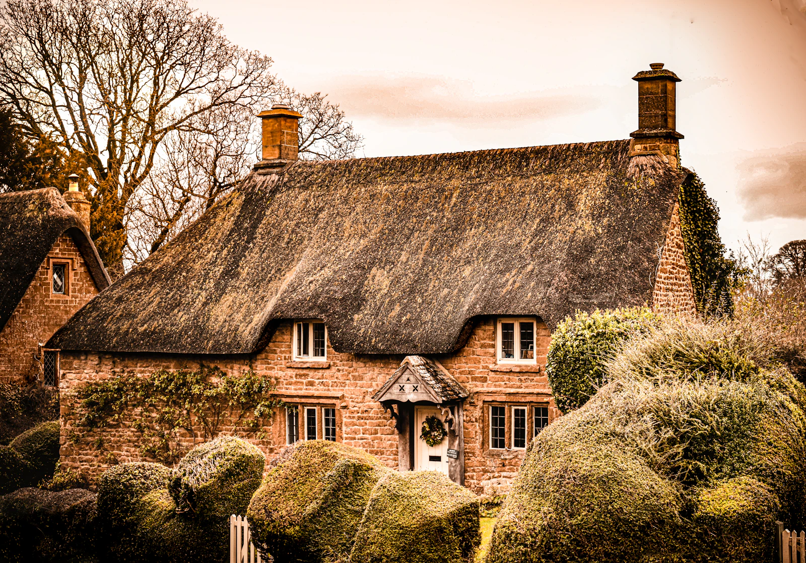 Stone house framed by garden planting