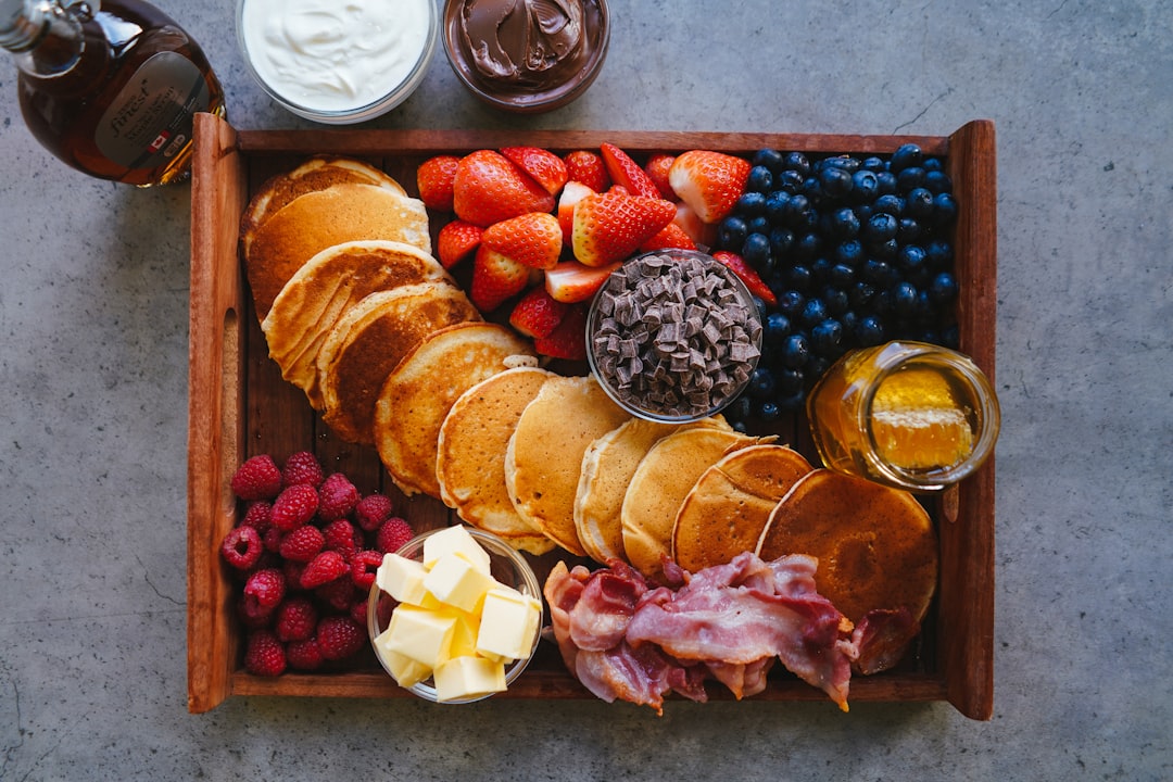 sliced bread and sliced fruits on brown wooden tray