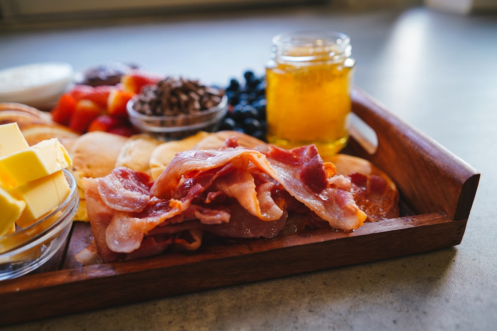 raw meat on brown wooden tray