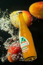 orange juice bottle on black table