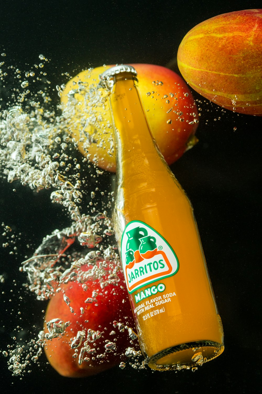 orange juice bottle on black table