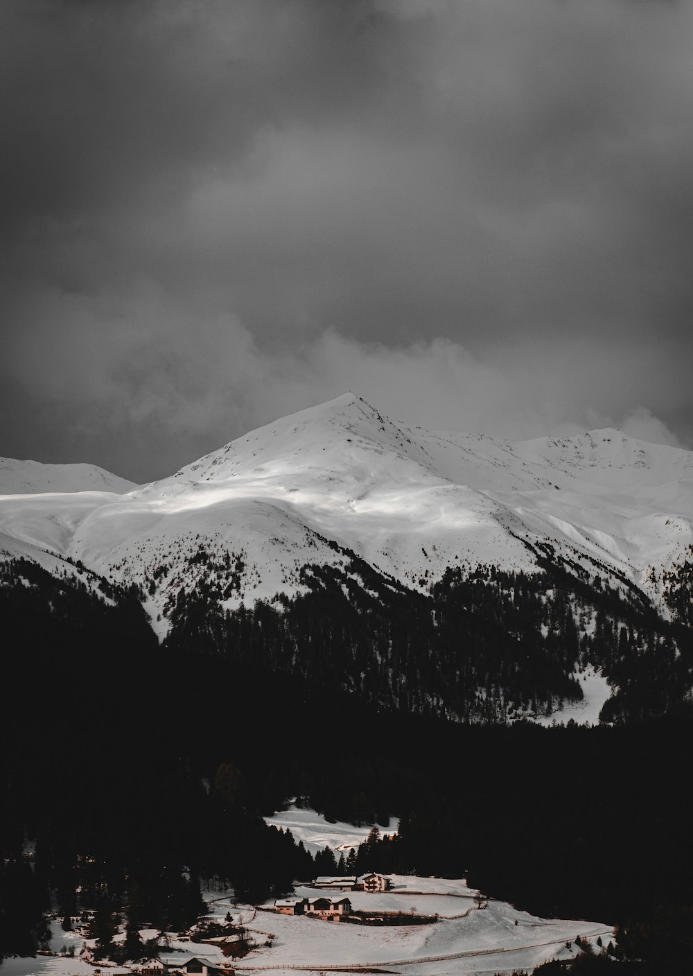 snow covered mountain under cloudy sky during daytime