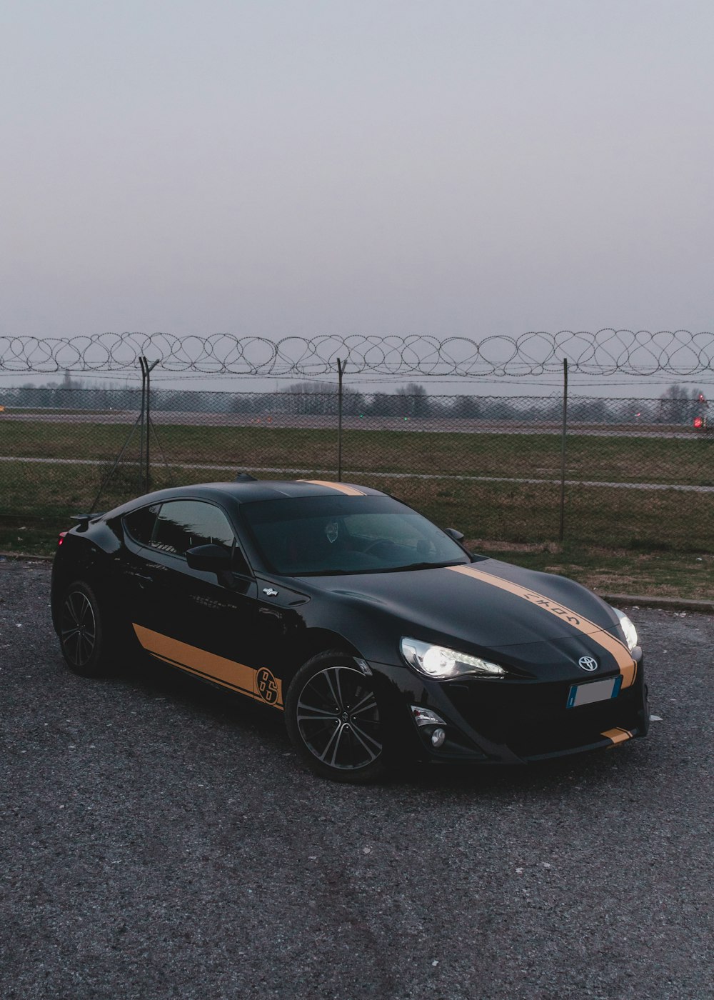 black porsche 911 parked on gray concrete road