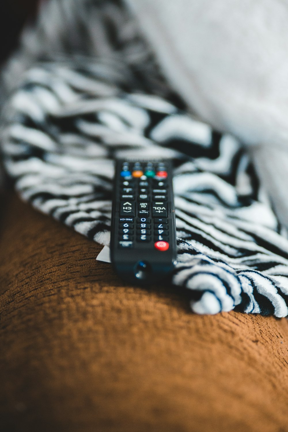 black remote control on brown textile