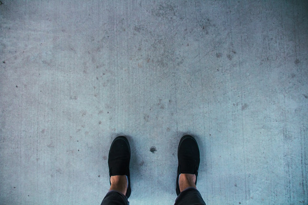 person in black slip on shoes