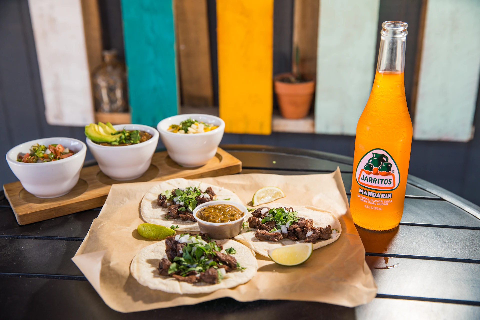 orange juice bottle beside green ceramic bowl with food