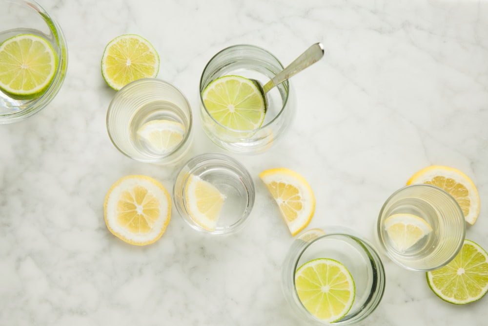 sliced lemon on clear drinking glass