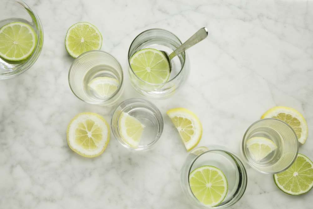 sliced lemon on clear drinking glass